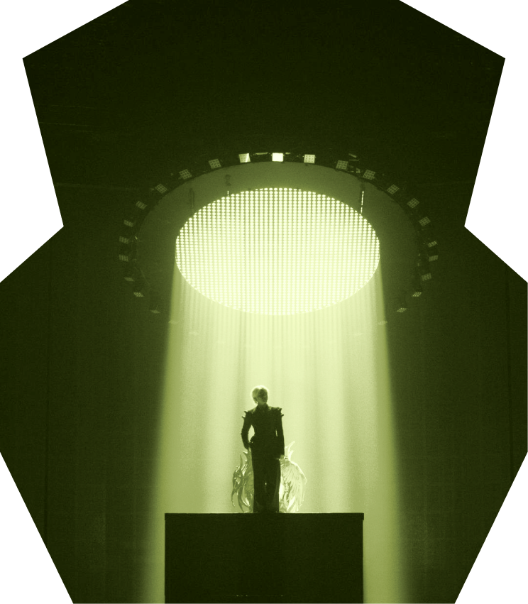 A single performer under a ring of light on the Music Hall stage